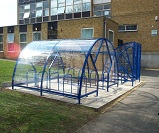 FS28 - Salisbury Minor open compound cycle shelter for 20 cycles, together with Harlan style 6 gated front cycle shelter for 6 cycles